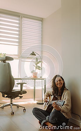 Creative hobby. Talented young female musician sit in armchair alone compose instrumental song using classic guitar. Copy space Stock Photo