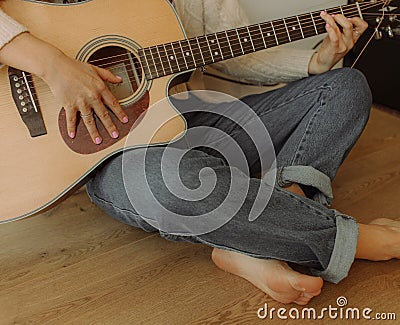Creative hobby. Talented young female musician sit in armchair alone compose instrumental song using classic guitar. Copy space Stock Photo