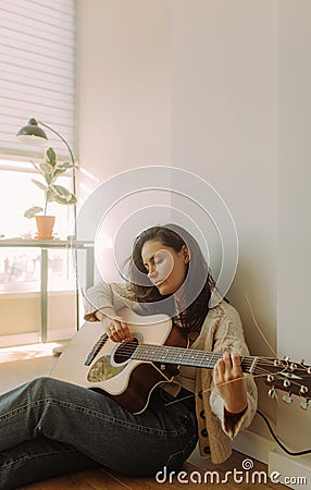 Creative hobby. Talented young female musician sit in armchair alone compose instrumental song using classic guitar. Copy space Stock Photo