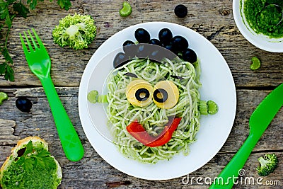 Creative idea for baby dinner or lunch - green spaghetti monster Stock Photo