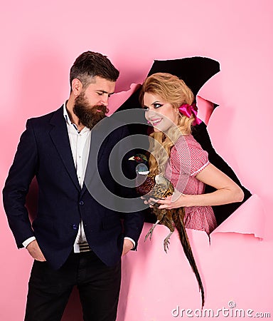 Creative idea. Bird flu. Funny advertising. Crazy couple on pink. Halloween. Vegetarian. vintage couple with poultry Stock Photo