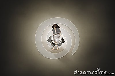 Creative idea concept of a surreal woman holding a lit light bulb Stock Photo