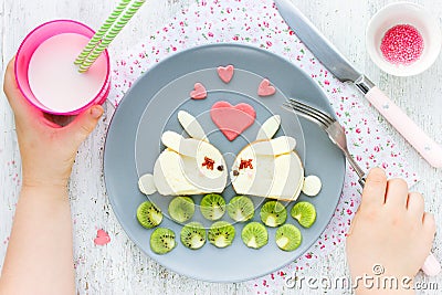 Creative idea for kid breakfast - cheese sandwich shaped cute white bunnies couple Stock Photo