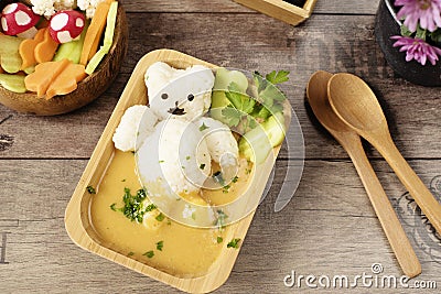 Creative idea for kids lunch or dinner. Children animal food. Bath with rice bear and cream soup. Mushrooms of radishes Stock Photo
