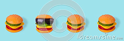 Creative idea made from a hamburger with sunglasses that is placed in a row with normal burgers Stock Photo