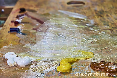 Creative image, artist`s palette with oil paints and brushes, close-up Stock Photo