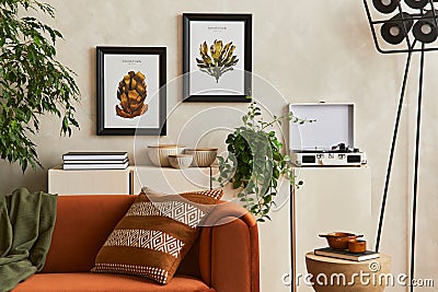 Creative interior composition of living room with designed couch, two mock up poster frames, coffee table, plants, industrial lamp Stock Photo