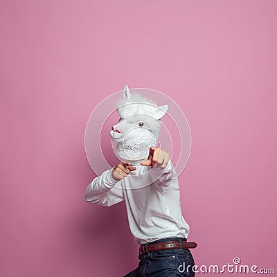Creative lama person pointing finger on bright pink studio wall background Stock Photo