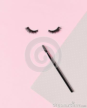 Creative layout with eyelashes and brush mascara. Closed eyes on pastel pink background. Stock Photo