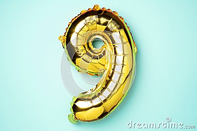Creative layout. Golden foil balloon number and digit nine 9. Birthday greeting card. Anniversary concept. Top view Stock Photo