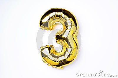 Creative layout. Golden foil balloon number and digit three 3. Birthday greeting card. Anniversary concept. Top view Stock Photo