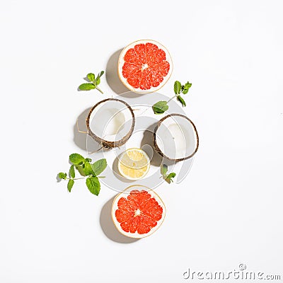 Creative layout made coconut, grapefruit, lemon and mint leaves Stock Photo