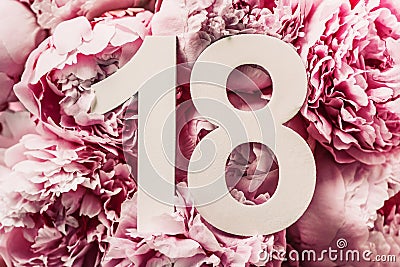 Creative layout. Peony flowers, digit eighteen. Birthday greeting card with inscription 18. Anniversary concept. Top view. Copy Stock Photo