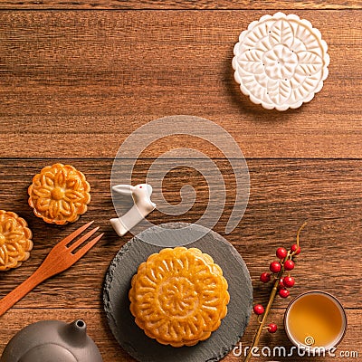 Creative Moon cake Mooncake table design - Chinese traditional pastry with tea cups on wooden background, Mid-Autumn Festival Stock Photo