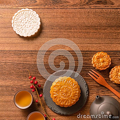 Creative Moon cake Mooncake table design - Chinese traditional pastry with tea cups on wooden background, Mid-Autumn Festival Stock Photo