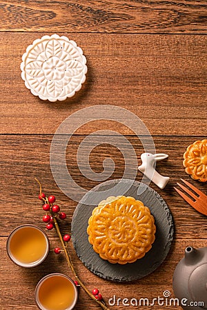 Creative Moon cake Mooncake table design - Chinese traditional pastry with tea cups on wooden background, Mid-Autumn Festival Stock Photo