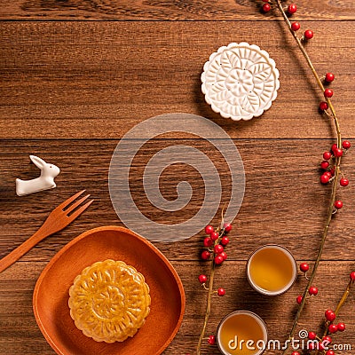 Creative Moon cake Mooncake table design - Chinese traditional pastry with tea cups on wooden background, Mid-Autumn Festival Stock Photo