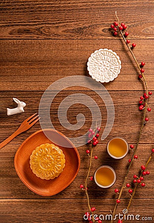 Creative Moon cake Mooncake table design - Chinese traditional pastry with tea cups on wooden background, Mid-Autumn Festival Stock Photo