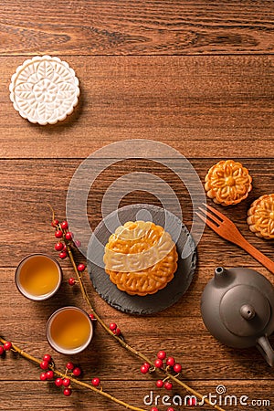 Creative Moon cake Mooncake table design - Chinese traditional pastry with tea cups on wooden background, Mid-Autumn Festival Stock Photo