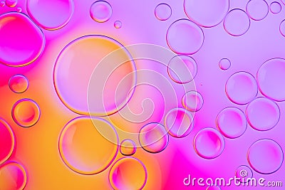 Creative neon background with drops. Glowing abstract backdrop with vibrant gradients on bubbles. Lilac, orange and pink Stock Photo