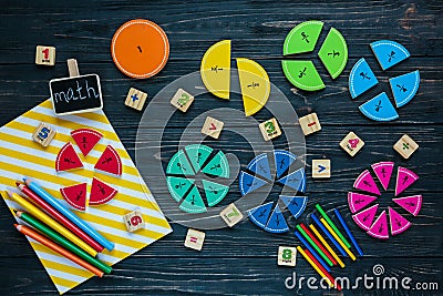 Creative Ð¡olorful math fractions on dark background. Interesting funny math for kids. Education, back to school concept Stock Photo