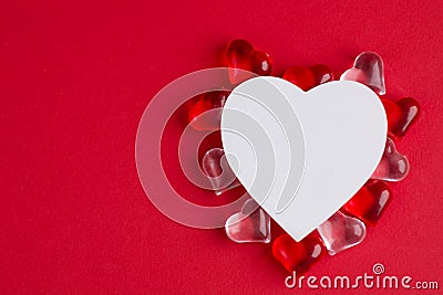 Creative outline with red glass hearts, paper heart on red pastel background. Top view, flat lay. Valentine's day Stock Photo