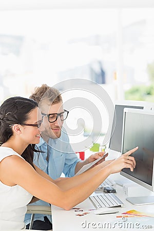 Creative partners working together on computer at their desk Stock Photo