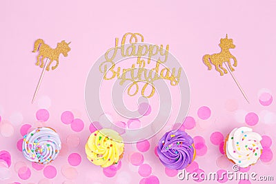 Creative pastel fantasy holiday card with cupcake, happy birthday lettering and unicorn. Baby shower, birthday, celebration Stock Photo