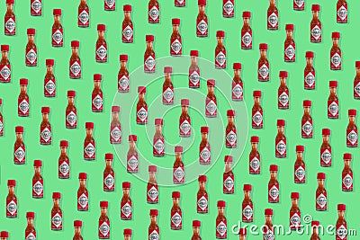 Creative pattern made of Mini bottle of Tabasco Chili Pepper Sauce. Editorial Stock Photo