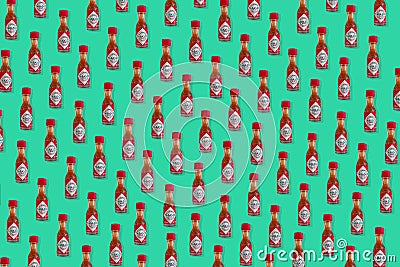 Creative pattern made of Mini bottle of Tabasco Chili Pepper Sauce. Editorial Stock Photo