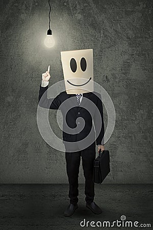 Creative person with a carton head and lamp Stock Photo