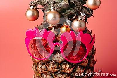 Creative pineapple with Christmas decorations on studio background Stock Photo