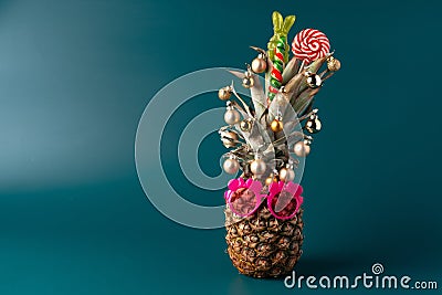 Creative pineapple with Christmas decorations on studio background Stock Photo