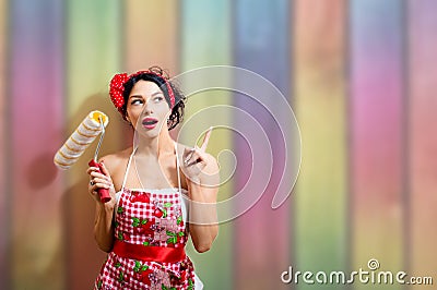 Creative pinup woman with paint roller Stock Photo