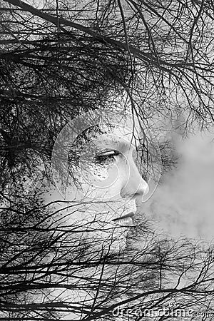 Creative portrait of beautiful young woman made from double exposure effect using photo of trees and nature Stock Photo