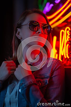 Creative portrait of a girl in neon lighting with glasses Stock Photo
