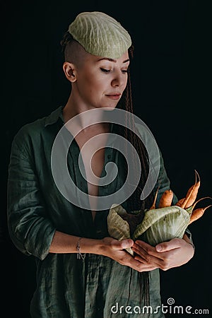 Creative portrait of vegan woman holding vegetables. Veganism, vegetarianism, plant-based diet Stock Photo