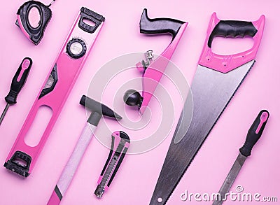 Creative provocation: a set of hand tools for construction and repair on a pink background. Stock Photo