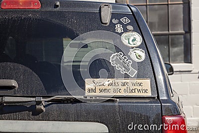 creative quote from Tobias Smollett : `Some folks are wise and some are otherwise` as a car sticker Editorial Stock Photo