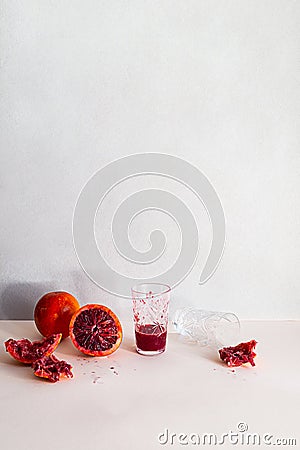 Creative realistic still life. Freshly squeezed orange juice in a crystal glass, whole orange and halves Stock Photo