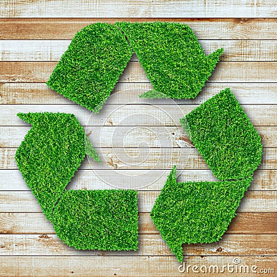 Recycle symbol from grass on wood background Stock Photo