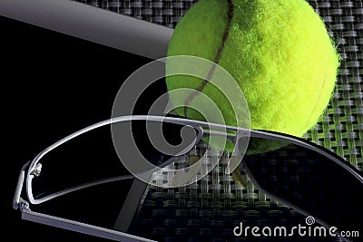 Creative Set Tennis ball, tablet computer and black sunglasses, close-up, on metal background. Stock Photo