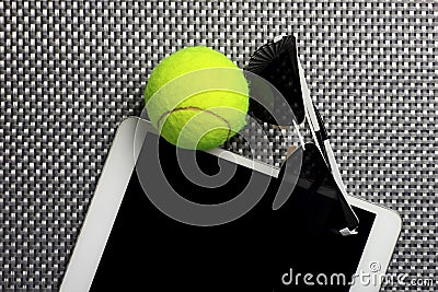 Creative Set Tennis ball, tablet computer and black sunglasses, close-up, on metal background. Stock Photo