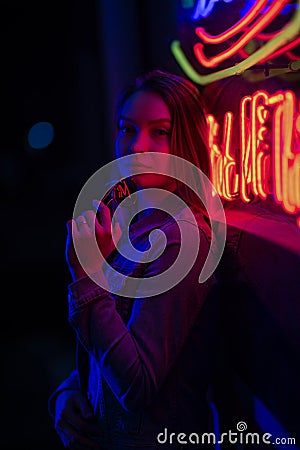 Creative sexual portrait of a girl in neon lighting with glasses Stock Photo