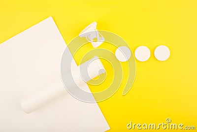 Creative flat lay with opened tube with effervescent vitamins on white and yellow background Stock Photo