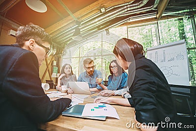 Creative team of professionals at the table meeting to discuss new ideas in modern startup office Stock Photo