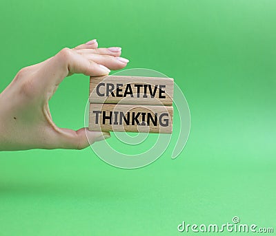 Creative thinkig symbol. Wooden blocks with words Creative thinkig. Beautiful green background. Businessman hand. Business and Stock Photo