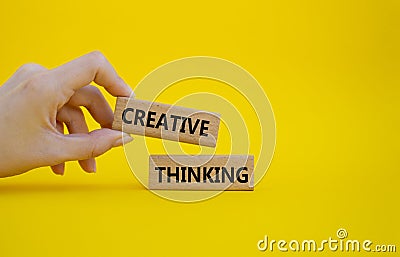 Creative thinkig symbol. Wooden blocks with words Creative thinkig. Businessman hand. Beautiful yellow background. Business and Stock Photo