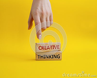 Creative thinkig symbol. Wooden blocks with words Creative thinkig. Businessman hand. Beautiful yellow background. Business and Stock Photo