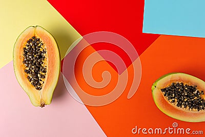 Creative tropical layout with papaya on colorful vivid paper. Minimal abstract summer concept. Flat lay Stock Photo